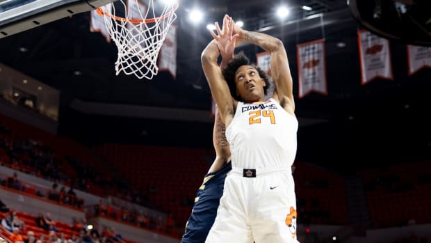 Dec 17, 2023; Stillwater, Okla, USA ; Oral Roberts Golden Eagles center Josh Jones (behind) knocks the ball away from Oklahoma State Cowboys forward Isaiah Miranda (24) in the first half of an NCAA basketball game at Gallagher Iba arena. Mandatory Credit: Mitch Alcala-The Oklahoman